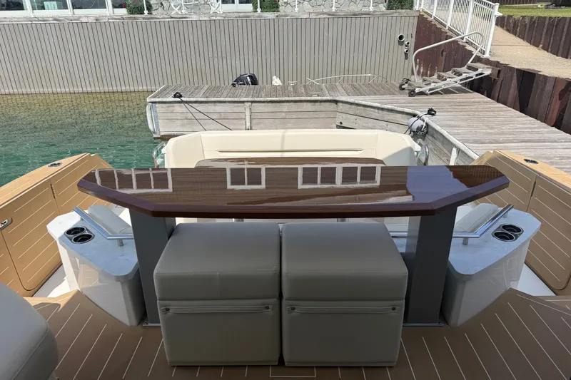 Slide: The Image of Luxury Tiara Yachts EX 54, 2027 model, docked with elegant seating and polished wood table. - 51
