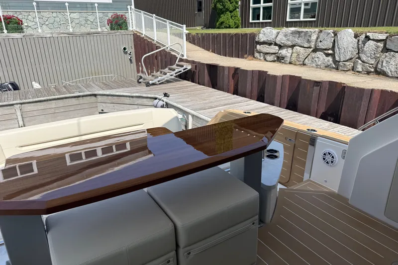 Slide: The Image of Luxury deck of 2027 Tiara Yachts EX 54 with polished wood table. - 53