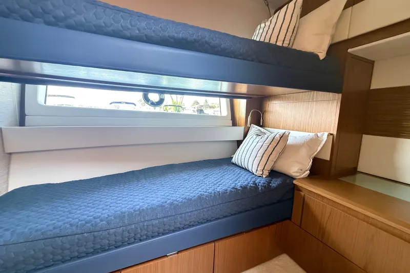 Slide: The Image of Cozy bunk beds in 2027 Tiara Yachts EX 54 cabin, featuring modern design and comfortable bedding. - 32