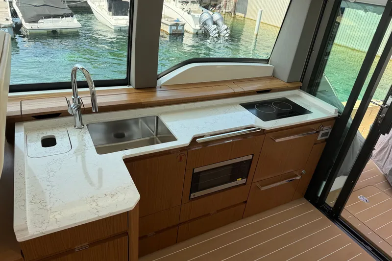 Slide: The Image of Modern kitchen in 2027 Tiara Yachts EX 54 with sleek countertops and appliances. - 18