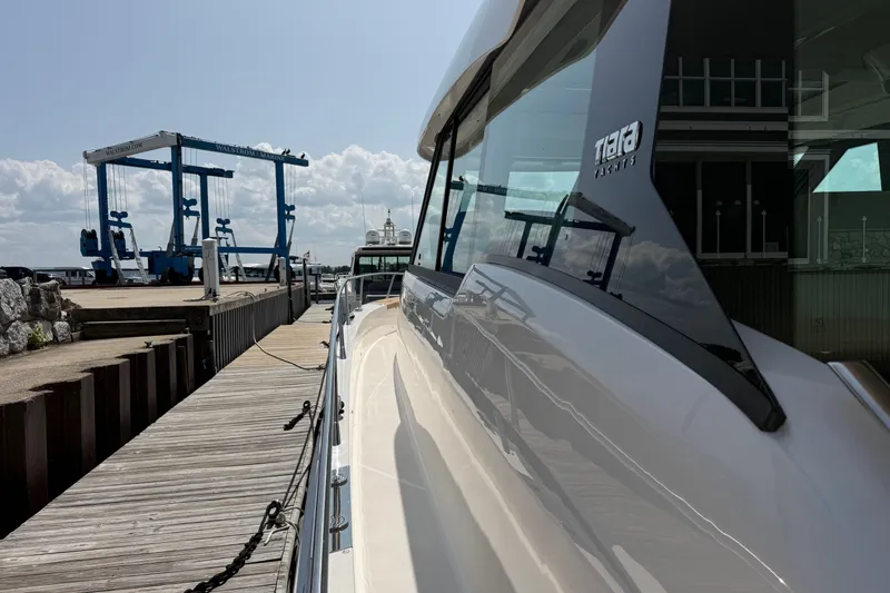 Slide: The Image of 2027 Tiara Yachts EX 54 docked at marina with clear sky. - 41