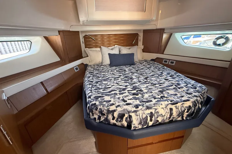 Slide: The Image of Luxurious bedroom interior of 2027 Tiara Yachts EX 54 with stylish bedding and wood accents. - 28