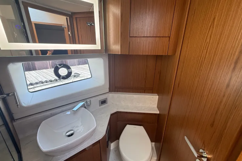 Slide: The Image of Luxurious bathroom in 2027 Tiara Yachts EX 54 with modern fixtures and wood cabinetry. - 35