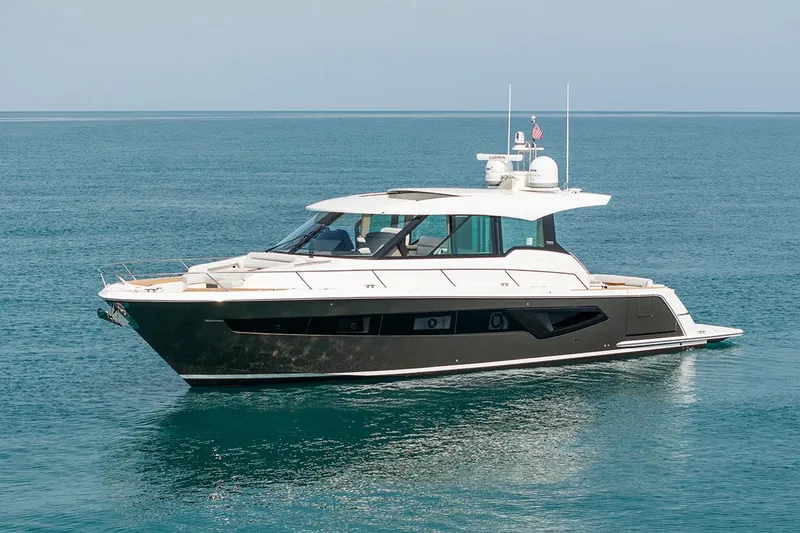 Slide: The Image of Manufacturer Provided Image: 2025 Tiara Yachts EX 54 luxury yacht cruising on calm blue waters. - 2