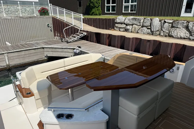 Slide: The Image of Luxury seating area on 2027 Tiara Yachts EX 54, docked at a marina. - 50