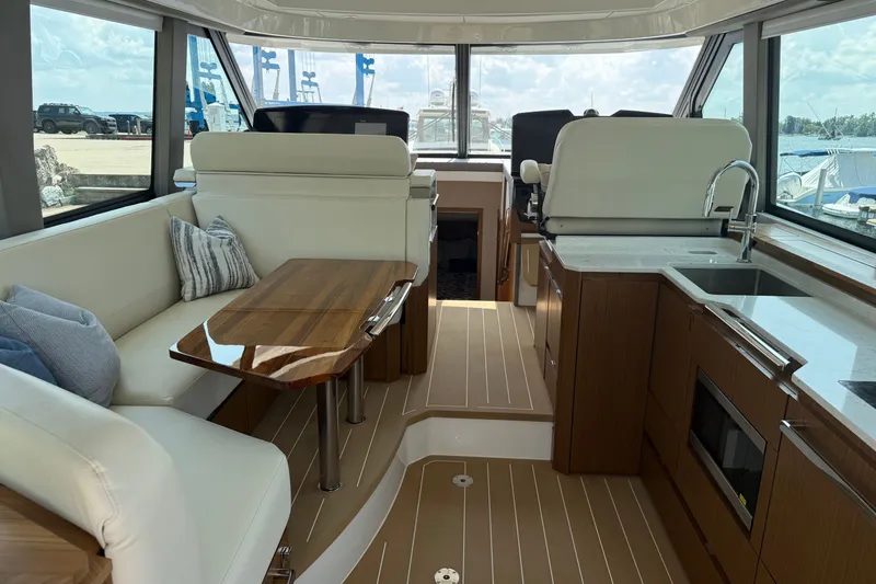 Slide: The Image of Luxurious interior of 2027 Tiara Yachts EX 54 with elegant seating and modern kitchen amenities. - 25