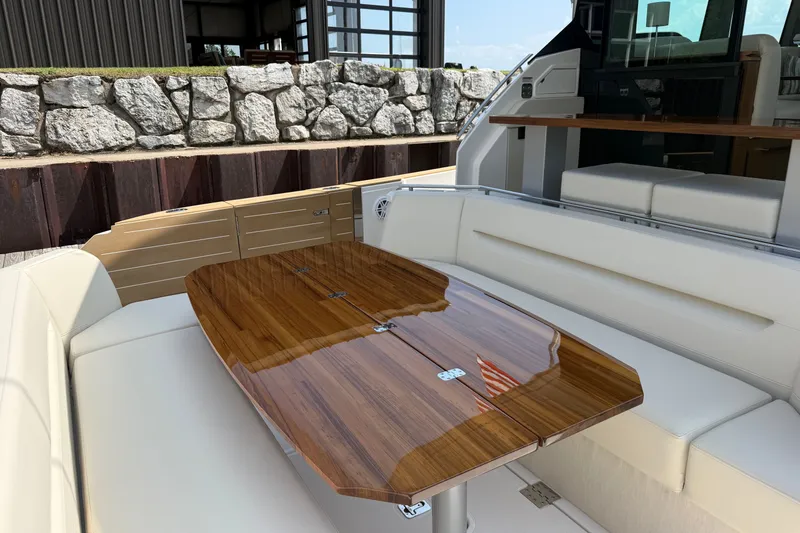 Slide: The Image of Luxurious seating area on 2027 Tiara Yachts EX 54 with elegant wooden table. - 47