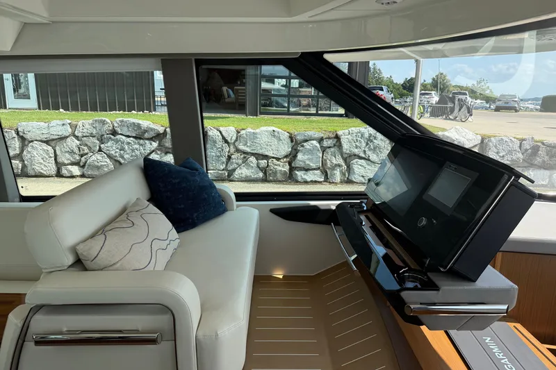 Slide: The Image of Interior of 2027 Tiara Yachts EX 54 with modern helm and plush seating. - 13