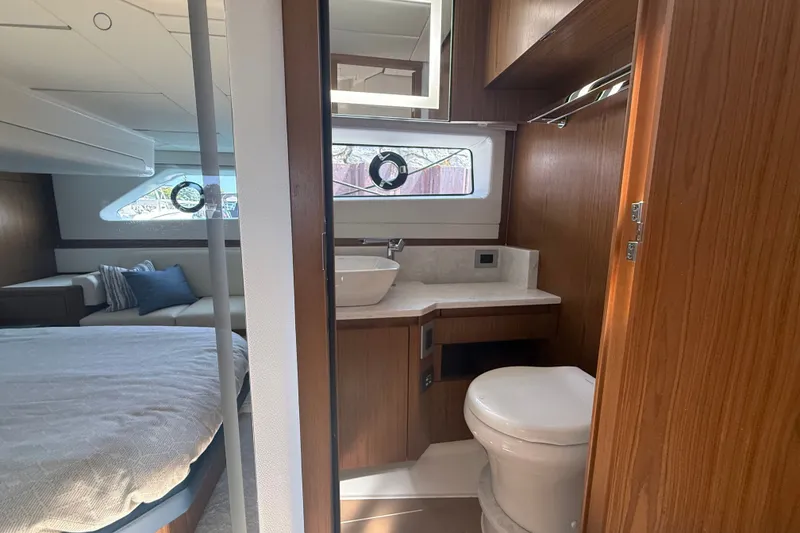 Slide: The Image of Luxurious interior of 2027 Tiara Yachts EX 54, featuring a modern bathroom and cozy bedroom. - 39