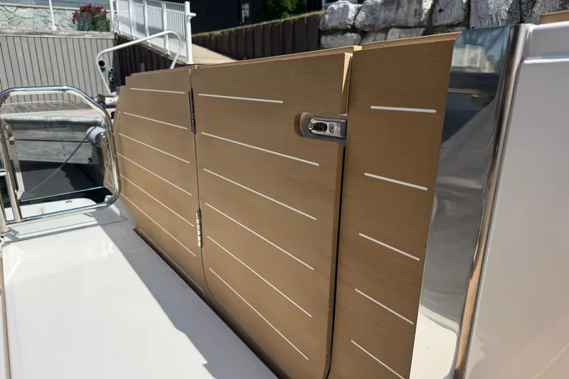 Slide: The Image of 2027 Tiara Yachts EX 54, sleek wooden paneling detail on deck. - 12