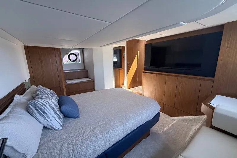 Slide: The Image of Luxurious bedroom interior of 2027 Tiara Yachts EX 54 with modern furnishings and large TV. - 37