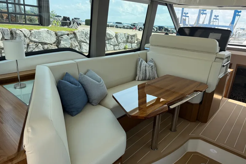 Slide: The Image of Luxurious interior of 2027 Tiara Yachts EX 54 with elegant seating and wooden table. - 16
