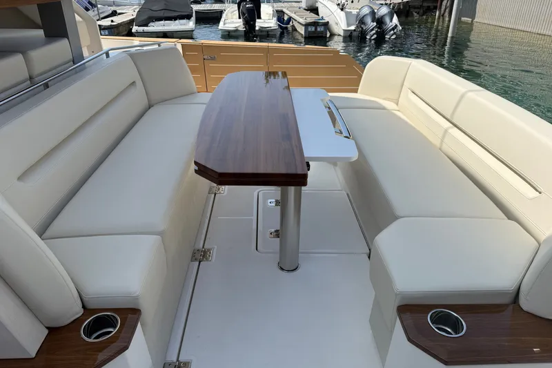 Slide: The Image of Luxurious seating area on 2027 Tiara Yachts EX 54 with elegant wooden table. - 57