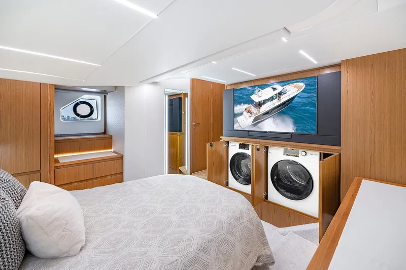 Slide: The Image of Manufacturer Provided Image: Luxurious 2025 Tiara Yachts EX 54 interior with modern bedroom and built-in laundry appliances. - 19