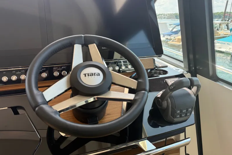 Slide: The Image of Steering wheel and controls of 2027 Tiara Yachts EX 54 boat cockpit. - 21