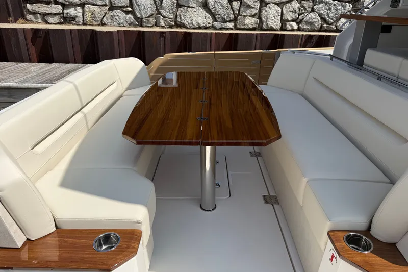Slide: The Image of Luxurious seating area on 2027 Tiara Yachts EX 54 with elegant wooden table. - 54