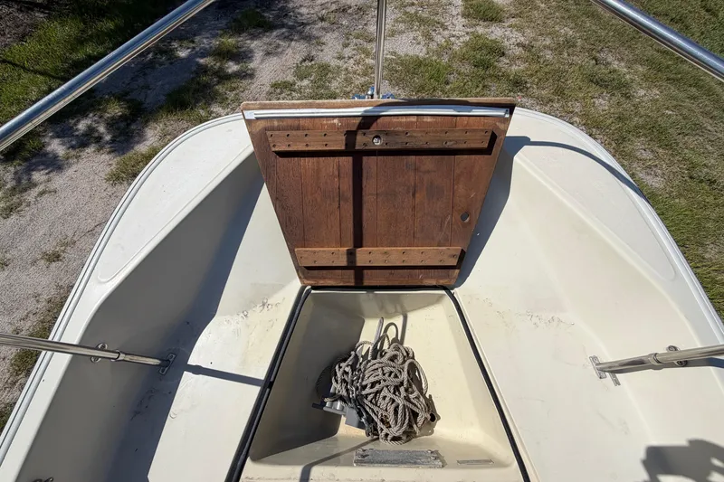 Slide: The Image of 1987 Boston Whaler 17 Montauk bow with wooden hatch and coiled rope. - 12