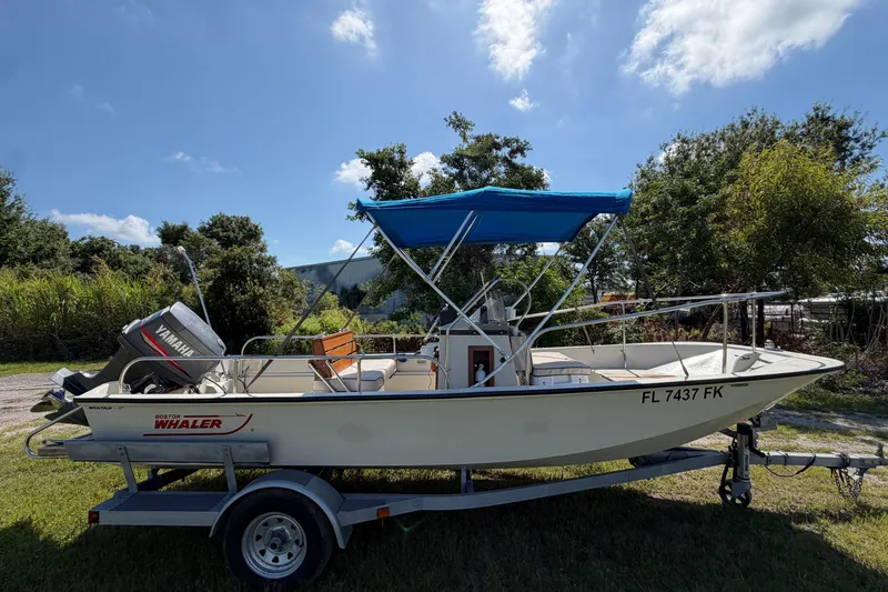 Slide: The Image of 1987 Boston Whaler 17 Montauk boat with Yamaha motor on trailer, outdoors. - 13