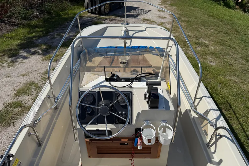 Slide: The Image of 1987 Boston Whaler 17 Montauk boat interior with steering wheel and controls. - 8