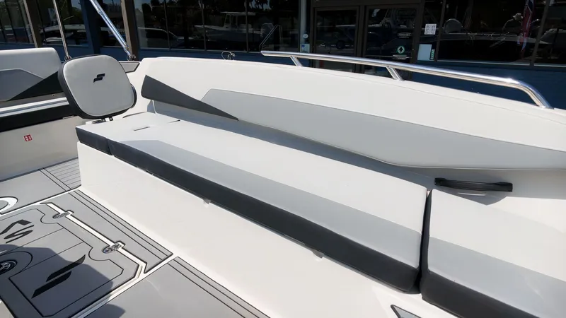 Slide: The Image of The image shows the deck of a 2027 Starcraft SV 18 OB boat with seating. - 13