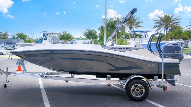 Slide: The Image of A 2027 Starcraft SV 18 OB boat on a trailer in a parking lot. - 3