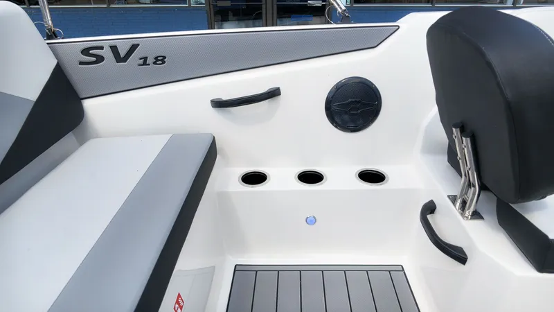 Slide: The Image of Interior view of a Starcraft SV 18 OB boat with seating and cup holders. - 9