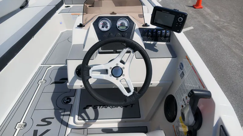 Slide: The Image of Helm of the Starcraft SV 18 OB with steering wheel and instruments. - 16