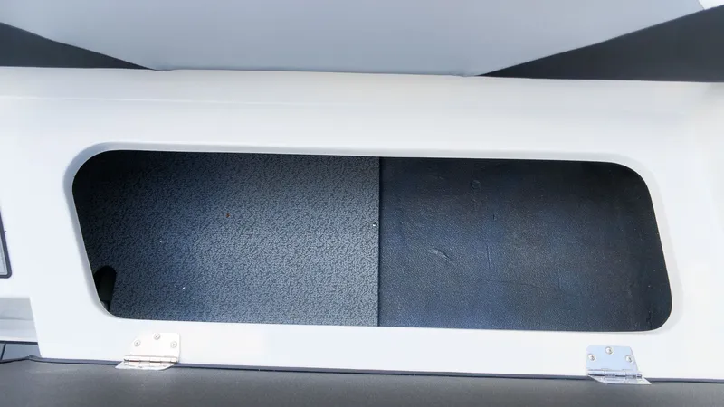 Slide: The Image of An open storage compartment on a boat with a gray interior. - 8