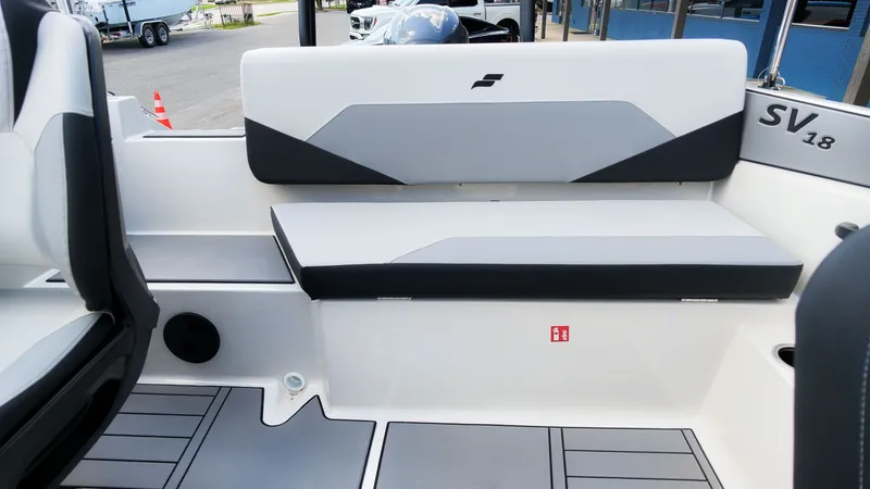 Slide: The Image of The image shows the interior of a Starcraft SV 18 OB boat with gray and white seating. - 6