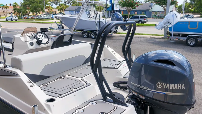 Slide: The Image of The image shows a Starcraft SV 18 OB boat with a Yamaha outboard motor, parked in a lot. - 3