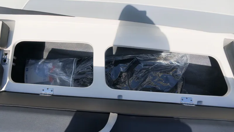 Slide: The Image of Boat storage compartment with two sections and plastic bags. - 11