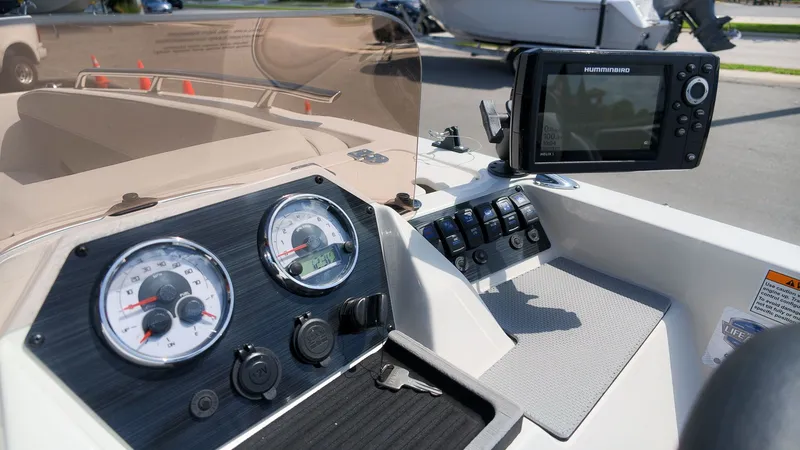 Slide: The Image of The image shows the dashboard of a Starcraft SV 18 OB boat with instruments and a screen. - 15