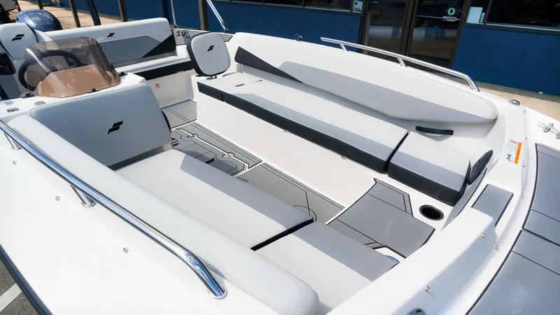 Slide: The Image of The image shows the spacious cockpit of a Starcraft SV 18 OB boat with gray upholstery. - 9