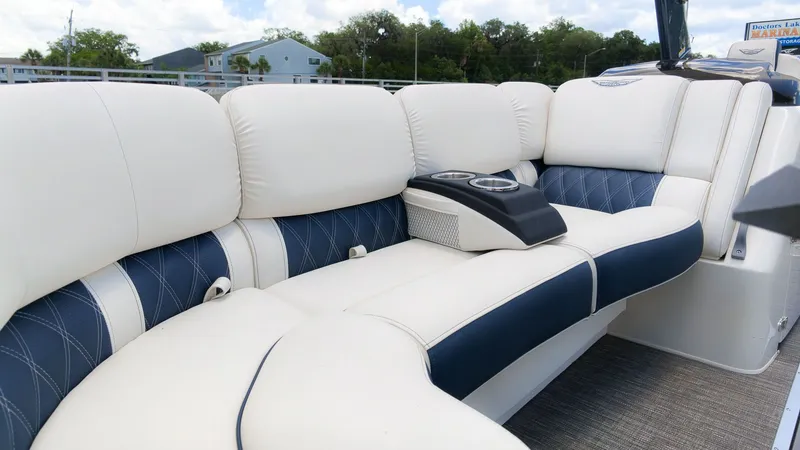 Slide: The Image of Luxurious white and blue seating on a boat with cup holders. - 22