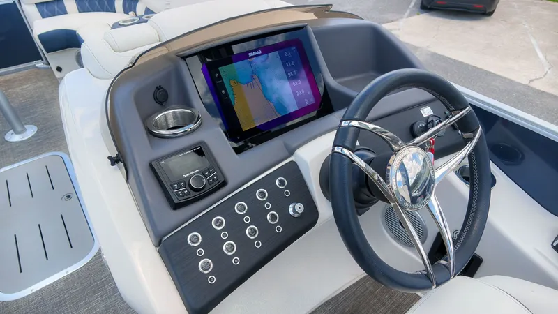 Slide: The Image of The image shows the helm of a 2024 Bennington 25 QFBA with a modern navigation system. - 26