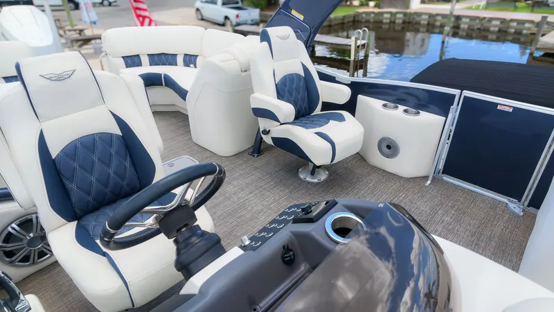 Slide: The Image of Luxurious pontoon boat with sleek seating, modern helm, and stylish design by the water. - 23