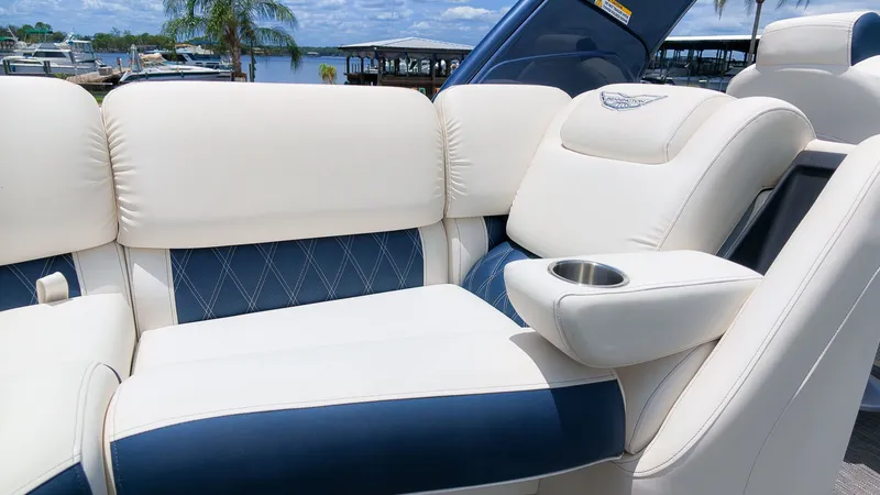 Slide: The Image of Luxurious white and blue seating on a boat with armrest and cup holder. - 13