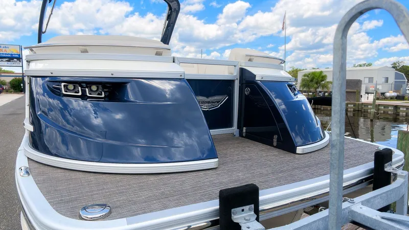 Slide: The Image of The image shows the rear of a 2024 Bennington 25 QFBA pontoon boat with sleek blue details. - 5