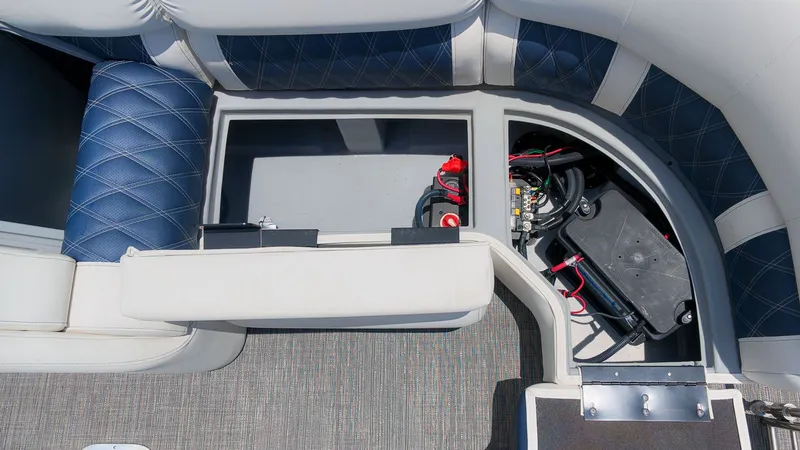 Slide: The Image of Interior view of a 2024 Bennington 25 QFBA with seating and battery compartment. - 9
