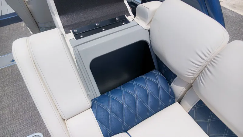 Slide: The Image of Close-up of a seating area with blue and white upholstery on a Bennington 25 QFBA boat. - 10