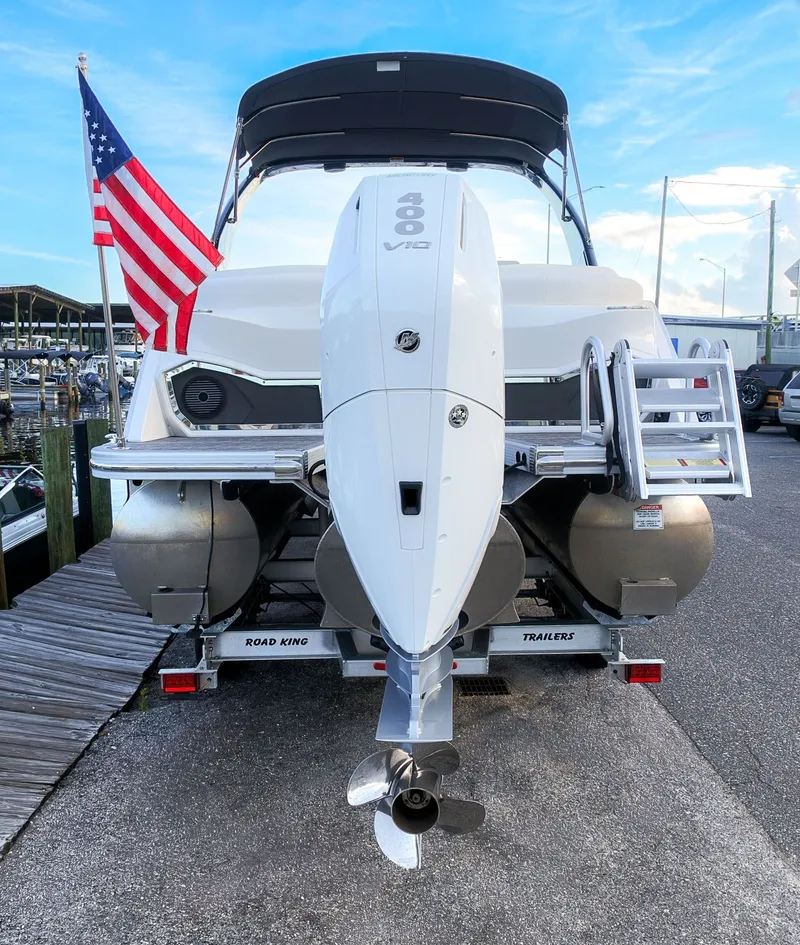 Slide: The Image of The image shows a 2024 Bennington 25 QFBA boat with a large outboard motor. - 6