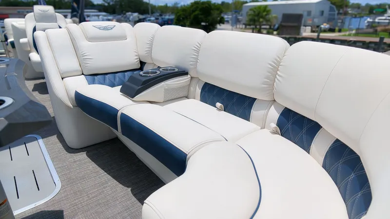 Slide: The Image of Luxurious white and blue seating on a boat, featuring cup holders in the center. - 15