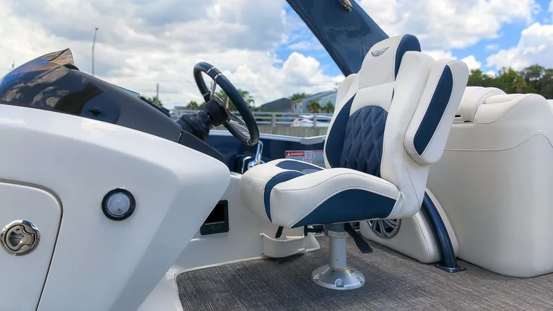 Slide: The Image of A luxurious seat on a modern boat with blue and white upholstery and a sleek helm. - 21