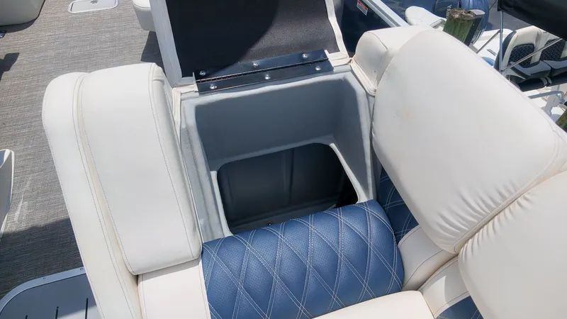 Slide: The Image of Seating area with storage on a 2024 Bennington 25 QFBA. - 16