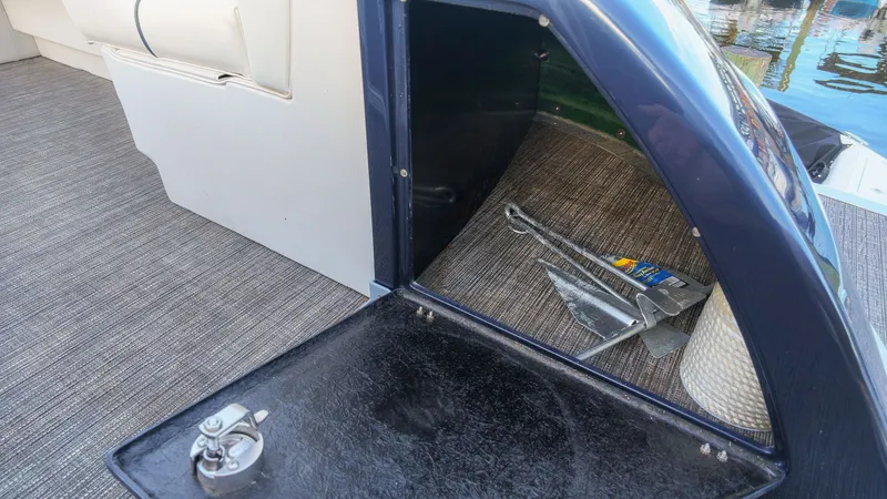 Slide: The Image of An open storage compartment on a boat with an anchor and rope. - 18