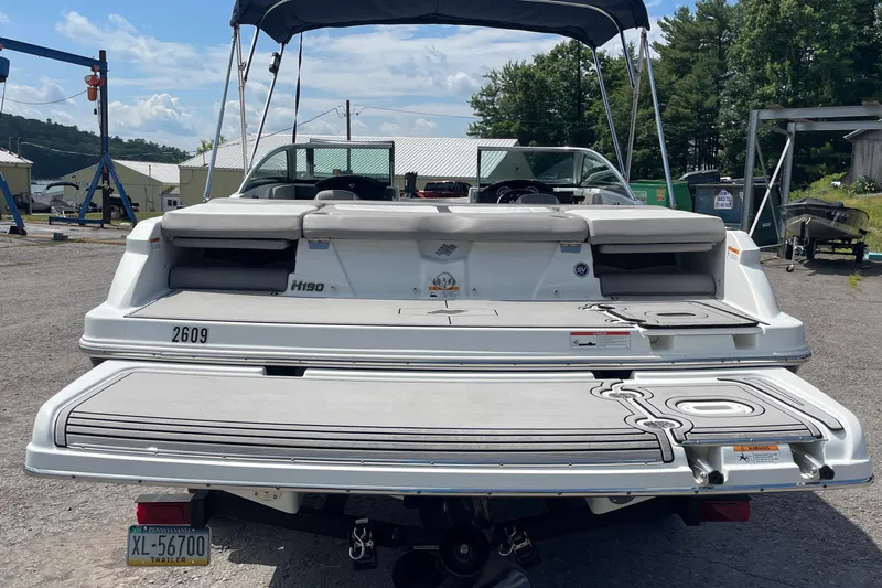Slide: The Image of 2020 Four Winns H190 boat with swim platform, parked outdoors on a sunny day. - 6