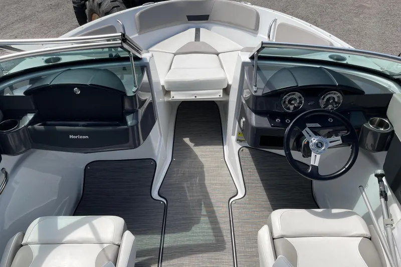 Slide: The Image of 2020 Four Winns H190 boat interior with steering wheel and seating area. - 16