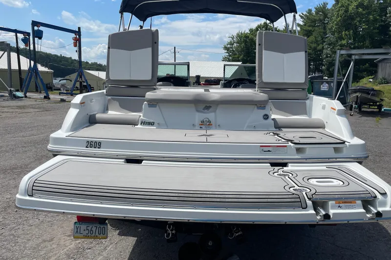 Slide: The Image of 2020 Four Winns H190 boat with spacious rear deck and seating, parked outdoors. - 9