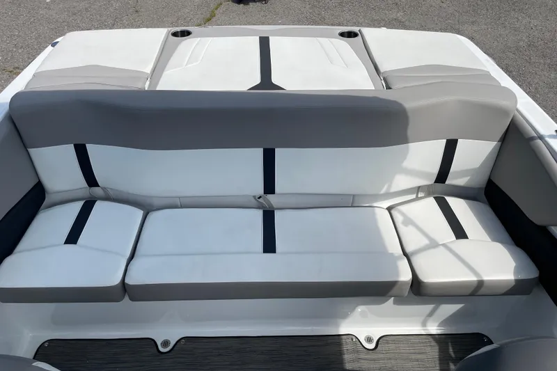 Slide: The Image of 2020 Four Winns H190 boat interior with gray and white seating, featuring cup holders. - 4