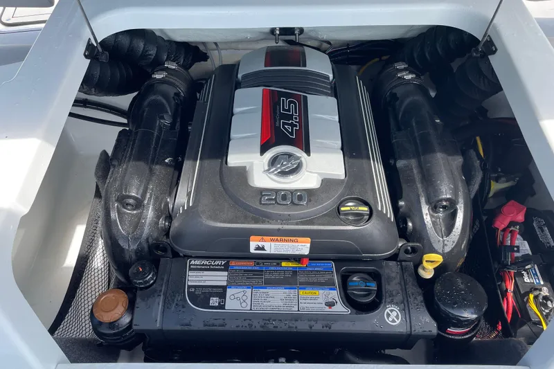 Slide: The Image of Engine compartment of a 2020 Four Winns H190 boat, featuring a Mercury 4.5L engine. - 15